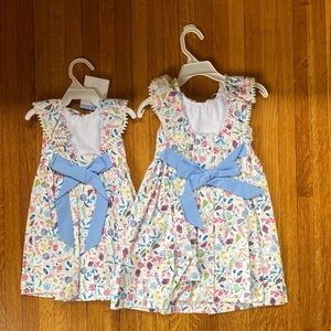 (2) bella bliss parisienne floral scalloped button back dress.Sizes 12M Size 2yr
